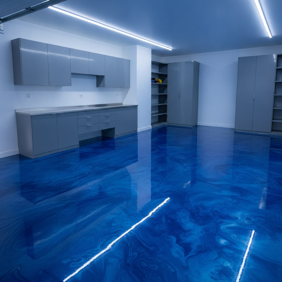 Garage floor finished in a bold blue metallic epoxy resin